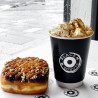 Customised black BIO-double wall paper cup with 'Black box donuts' logo used to serve a cup of hot cocoa